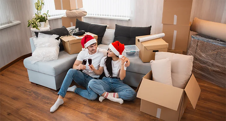 pareja en navidad acomodando las cosas en su nuevo hogar